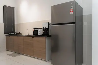 a kitchen with a stainless steel refrigerator at VibeHaus Snooker SimpangAmpat ``` 4Room10Pax3Bath in Simpang Ampat