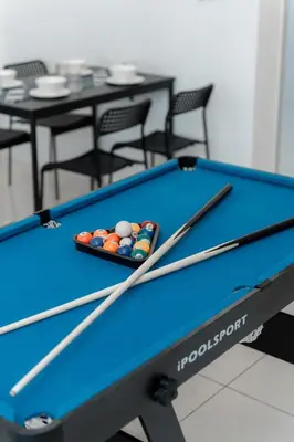 a pool table with cue balls on top of it at VibeHaus Snooker SimpangAmpat ``` 4Room10Pax3Bath in Simpang Ampat