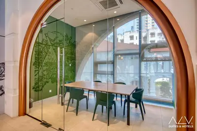 a dining room with a table and chairs and a window at 22 Macalisterz's Armoire Collection by ALV in George Town