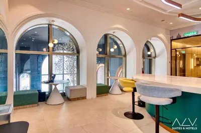 a lobby with a counter and chairs and windows at 22 Macalisterz's Armoire Collection by ALV in George Town