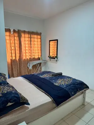 a bedroom with a bed and a window at AYAAN MUSLIMAH Home at Tanah Rata in Tanah Rata