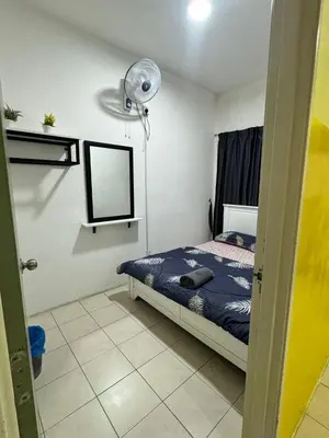a bedroom with a bed and a lamp in it at AYAAN MUSLIMAH Home at Tanah Rata in Tanah Rata