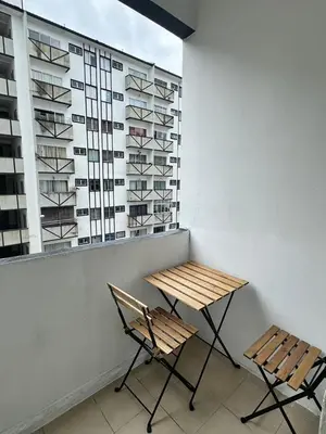 two chairs and a table in a room with a window at AYAAN MUSLIMAH Home at Tanah Rata in Tanah Rata