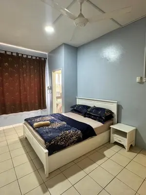 a bedroom with a bed and a blue wall at AYAAN MUSLIMAH Home at Tanah Rata in Tanah Rata