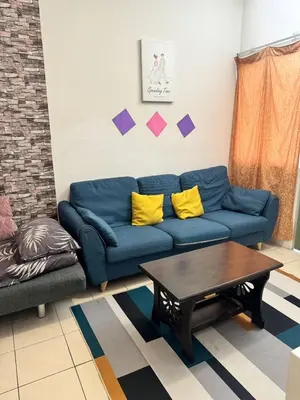 a living room with a blue couch and a table at AYAAN MUSLIMAH Home at Tanah Rata in Tanah Rata