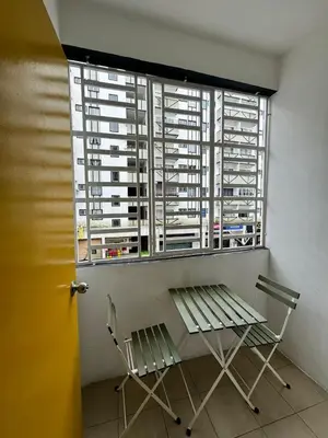 a window with two chairs and a bench in front of it at AYAAN Budget Homestay at Tanah Rata in Tanah Rata