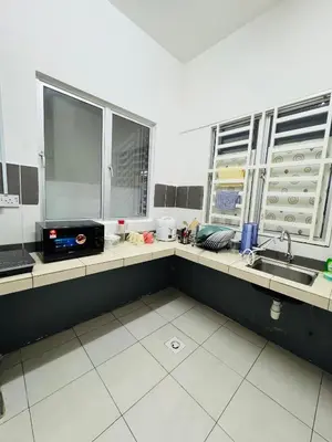 a kitchen with a counter with a sink and two windows at AYAAN Budget Homestay at Tanah Rata in Tanah Rata