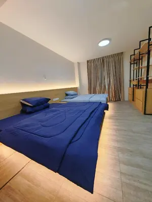 two beds in a room with blue sheets at Ipoh M Villa 2 in Ipoh