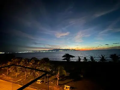 a view of the ocean at sunset with palm trees at Seaview Master Room - Ensuite Bath in Butterworth in Butterworth