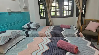 a bedroom with a large bed with pillows on it at Rumah Inap Haziq in Seri Manjung