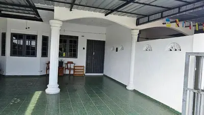 an empty room with columns and a room with a table at Rumah Inap Haziq in Seri Manjung