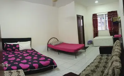 a bedroom with a bed and a bench in a room at Homestay No 68 Raub in Raub