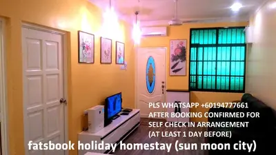 a room with a tv and a room with a door at Fastbook Sun Moon City Home 12Pax in Ayer Itam