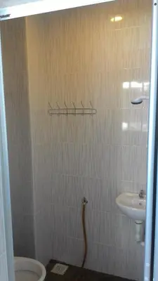 a bathroom with a shower with a sink and a toilet at Fastbook Sun Moon City Home 12Pax in Ayer Itam