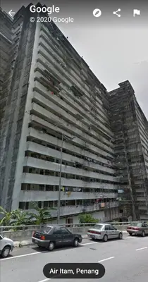 a large building with cars parked in front of it at Fastbook Sun Moon City Home 12Pax in Ayer Itam