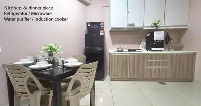 a kitchen with a table with chairs and a kitchen and a refrigerator at H2H - Majestic A19 stay station - 5pax in Ipoh