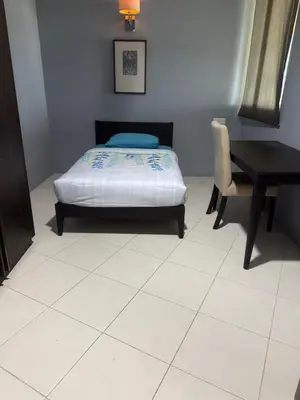 a bedroom with a bed and a table and a desk at 2Bedroom Condo at Cinta Sayang Resort in Sungai Petani