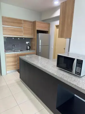 a kitchen with a counter top with a microwave at 2Bedroom Condo at Cinta Sayang Resort in Sungai Petani