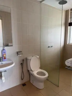 a bathroom with a toilet and a shower and a sink at Premium Condo at Cinta Sayang Club in Sungai Petani