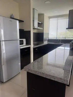a kitchen with a stainless steel refrigerator and a microwave at Executive Apartment at Cinta Sayang Club in Sungai Petani