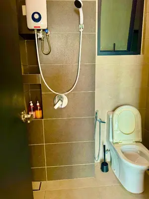 a small bathroom with a shower and a toilet at urban suites 3 bedroom 10pax a29 in Jelutong