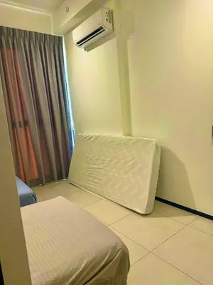 a room with a bed and an air conditioner at urban suites 3 bedroom 10pax a29 in Jelutong