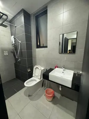 a bathroom with a toilet and a sink and a mirror at urban suites 3 bedroom 10pax a29 in Jelutong