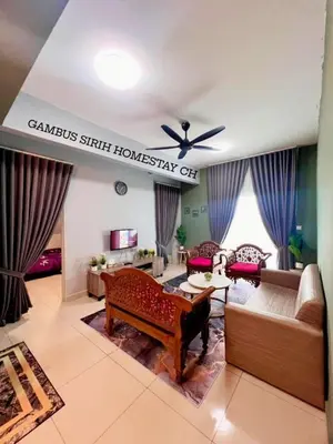 a living room with a couch and a table at Gambus Sireh Homestays in Tanah Rata