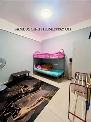 a room with a bunk bed and a sign on the wall at Gambus Sireh Homestays in Tanah Rata