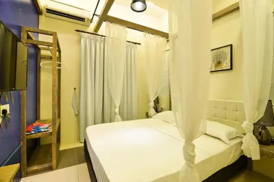 a bedroom with a white bed with a canopy at Parkview Homes in Ipoh