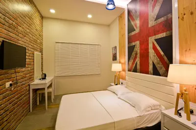 a bedroom with a bed and a brick wall at Parkview Homes in Ipoh