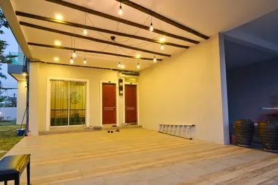 a patio with a wooden floor and lights at Parkview Homes in Ipoh