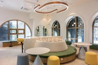 a lobby of a store with tables and chairs at 22 Macalisterz by YourSuperhost in George Town