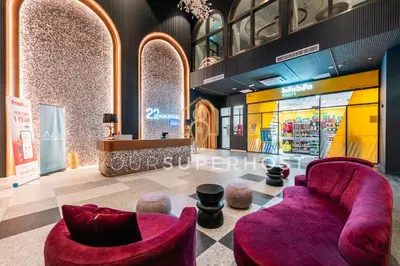 a lobby with a purple couch and chairs in a store at 22 Macalisterz by YourSuperhost in George Town