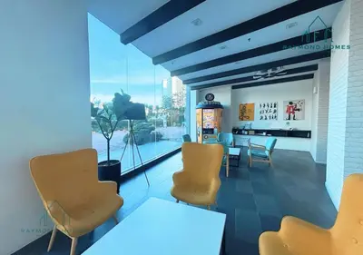a waiting room with chairs and a table and a window at Harborlight Jazz Suite in Tanjong Tokong