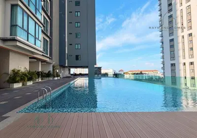 a large swimming pool in the middle of a building at Harborlight Jazz Suite in Tanjong Tokong