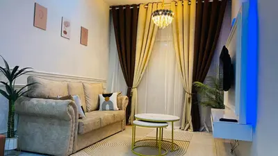 a living room with a couch and a stool at Prima Lodge Homestay in Kulim
