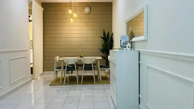 a dining room with a table and chairs in a house at Prima Lodge Homestay in Kulim