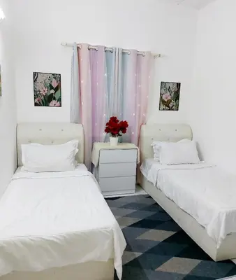 two beds sitting next to each other in a room at Fz North Meru Impian in Ipoh
