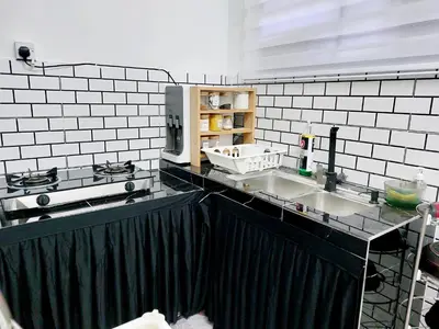 a kitchen with two sinks and a counter top at Fz North Meru Impian in Ipoh