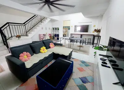 a living room with a couch and a dining room at Fz North Meru Impian in Ipoh