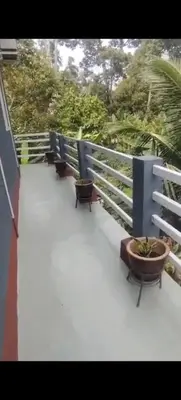 a row of benches sitting on a balcony at Teratak Desa Cemerlang 2 in Kuala Kangsar