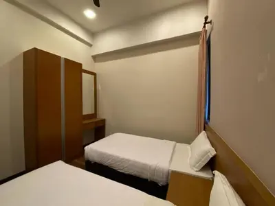 a small room with two beds in it at Nova Homestay Cameron Highlands in Brinchang