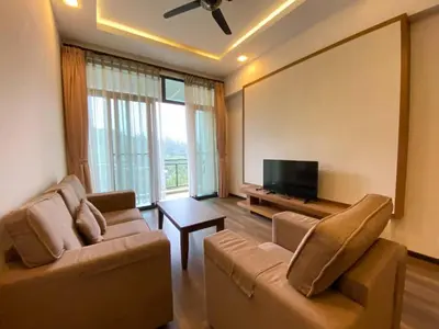 a living room with two couches and a flat screen tv at Nova Homestay Cameron Highlands in Brinchang