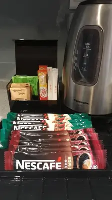 a counter with a microwave and a box of food at Urbano Luxury Homestay at Maritime in George Town