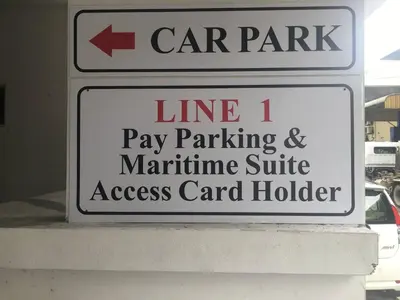 a street sign for a car park and pay parking andmarine suite access car holder at Urbano Luxury Homestay at Maritime in George Town