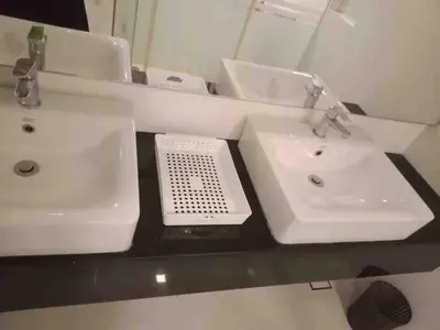 a bathroom with two white sinks and a mirror at Urbano Luxury Homestay at Maritime in George Town