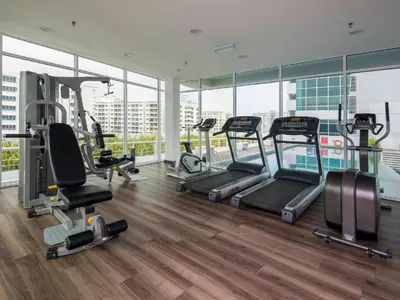 a gym with treadmills and ellipticals in a building at Urbano Luxury Homestay at Maritime in George Town