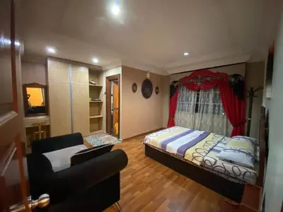 a bedroom with a bed and a couch at Crown Imperial Court - Arsad Homestay Brinchang in Brinchang