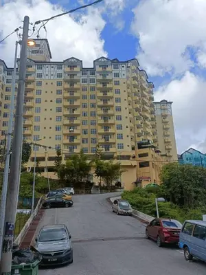 a large building with cars parked in a parking lot at Crown Imperial Court - Arsad Homestay Brinchang in Brinchang